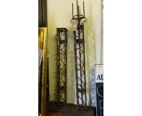 A pair of reclaimed iron work stands/lamp brackets ? with decorative S scroll detail