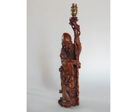 A Chinese carved wood table lamp in the form of a Sage, 47 cm high approx.