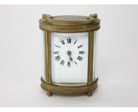 Brass and bevelled glass oval carriage clock