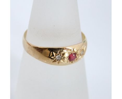 An 18ct gold ruby and diamond ring, small central star set ruby accented with illusion set diamonds. 2.6g. Ring size M