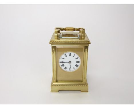 A good gilt brass striking carriage clock, with gilt mask and 4.5 cm enamel dial, the clock 12 cm high