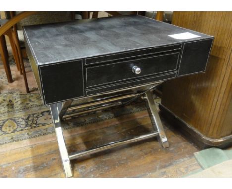 A contemporary leather and chrome coffee/lamp table by Andrew Martin, fitted with a single cylindrical upon X shaped supports