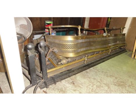 A collection of five Victorian and later fenders of varying design including a brass example with serpentine outline and pier