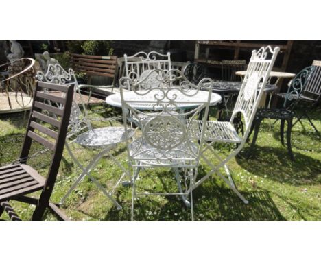 A cast aluminium garden terrace table of circular form with decorative pierced top raised on shaped tripod supports together 