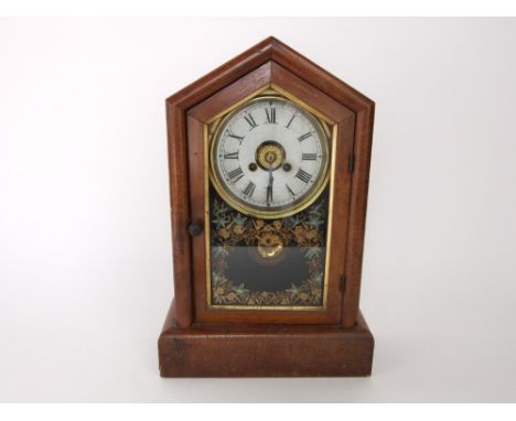 A walnut veneered glass fronted American shelf clock with two train circular dial and painted glass front, 39 cm high