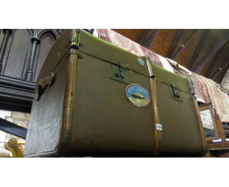 A vintage steel travel trunk together with a further canvas travelling trunk with brass fittings
