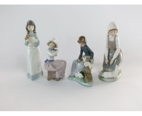 A collection of Lladro Daisa and Nao figures of children including a young girl kneeling beside a lamb, a girl carrying a pup