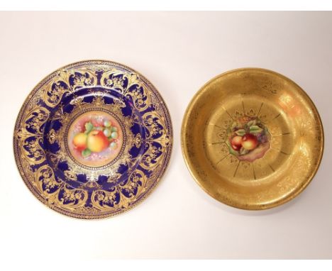 A Royal Worcester blue ground cabinet plate with central painted panel of fruit signed D Shinnie, with elaborate gilt scrolli