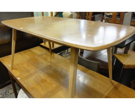 A good and rare Ercol extending dining table fitted with two extra leaves.