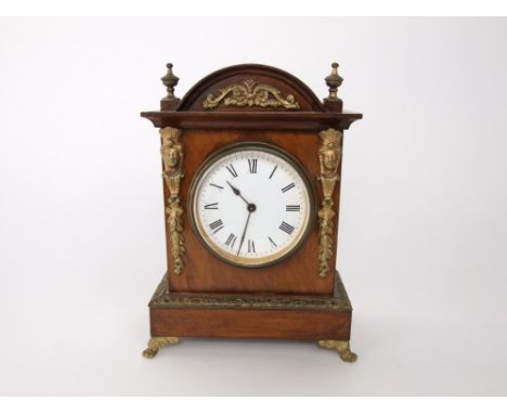 A continental walnut and ormolu mounted mantle clock, the 9 cm enamel dial within an architectural type case, 23 cm high
