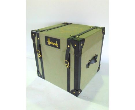 A leather and canvas trunk inscribed Harrods.