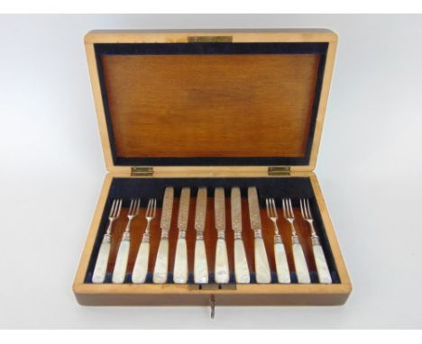 A cased set - six pairs of silver bladed dessert knives and forks with mother of pearl handles, Sheffield 1908