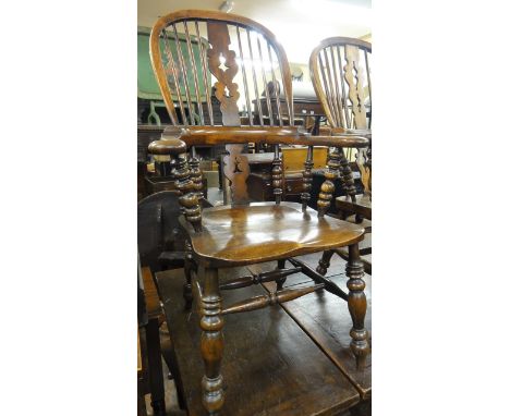 A Georgian Windsor comb back elbow chair with carved and pierced splats in mixed woods.