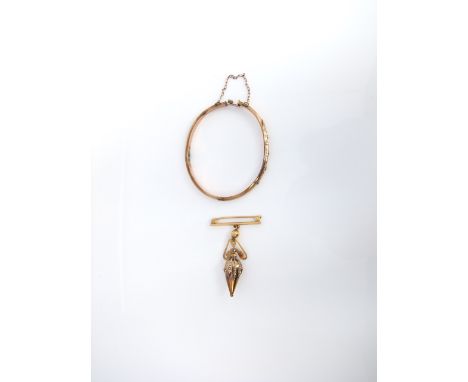 An early 20th century 9ct gold bangle with chased and engraved decoration together with a yellow metal pin brooch, total weig