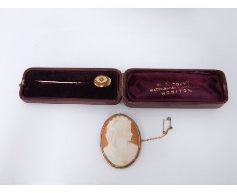 A shell cameo brooch mounted in a 9ct gold surround depicting a well carved image of a classical female together with a yello