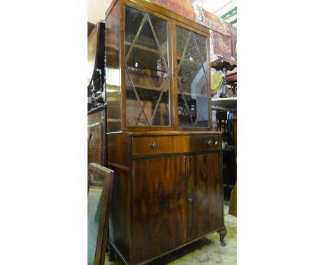 An art deco walnut veneer two tier side cupboard the lower section enclosed by two doors and two drawers, the upper section h