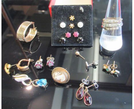 A collection of gold and yellow metal gemset earrings including a pair of ruby and diamond studs and a pair of diamond studs 