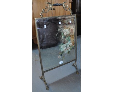 Art Nouveau brass framed bevel plate mirrored firescreen with painted foliage and turned handle. (B.P. 21% + VAT) 