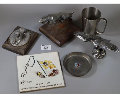 Box containing chrome mascots, including jaguar, eagle and sphinx, together with a motor racing tile dated 1962 Nederland, et
