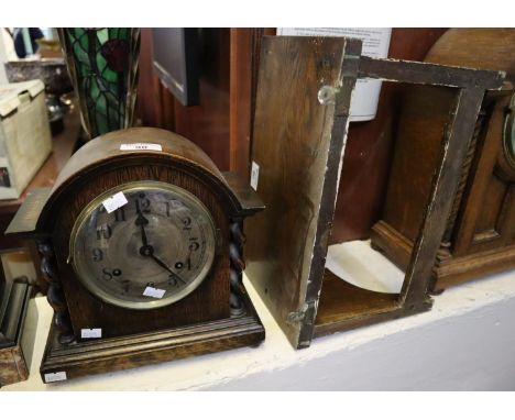 Early 20th century oak two-train barley twist mantel clock of domed form, together with an oak wall shelf with shaped sides. 