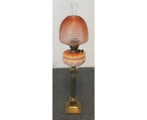 Early 20th century double oil burner lamp with an orange, etched foliate shade above a moulded orange reservoir standing on a