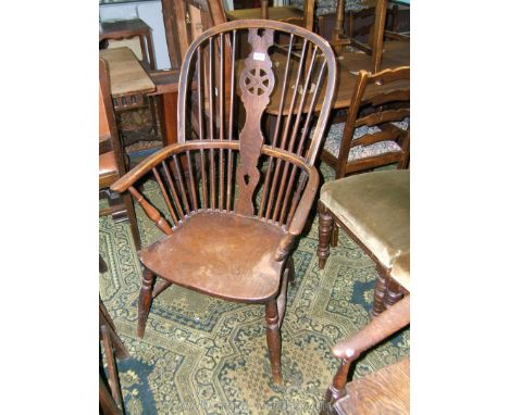 A late 18th c. Elm and Ash Windsor Chair, having bent Ash hoop back and arm, central Oak Wheelback splat with lower piercing,