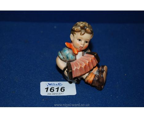 A small Goebel. West Germany, Hummel of a little boy playing a squeeze box 