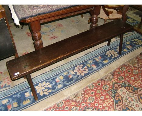 A 19th c. stained Pine Bench seat, having rectangular plank top on four spoke shaved legs. 60" long x 15" high x 10 1/4" wide