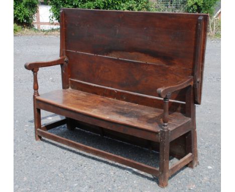 A substantial 18th c. country-made Monk's Bench/Table Settle, having two Elm plank top/back with shaped rail, held in place b