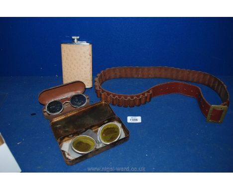 A leather cartridge Belt, pair of goggles in a tin, pair of old glasses in a tin case and hip flask.