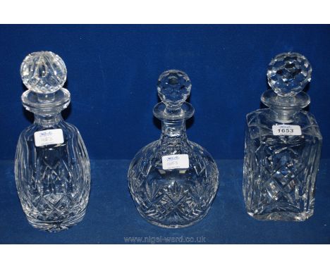 A cut glass square Decanter and stopper, a dumpy cut glass Decanter and stopper and a bottle-shaped Decanter with stopper