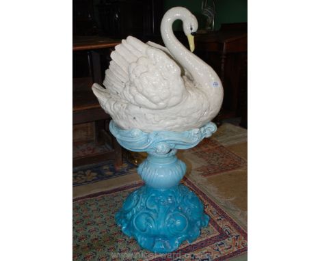 An unusual T.S. & S.L. of England garden Planter in shape of a swan, and blue stand simulating water fountain, 36'' high over