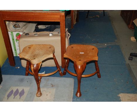 A pair of wooden tractor seat shaped Stools