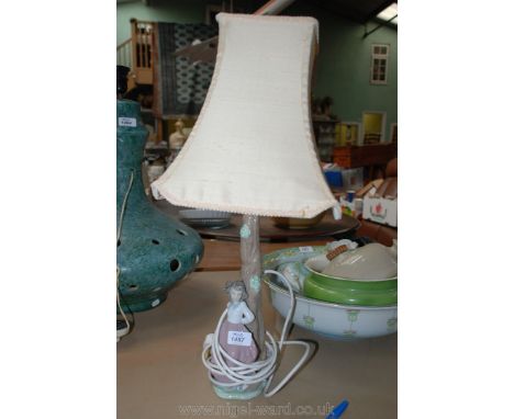 A Nao Table Lamp with a figure of a girl leaning against a tree