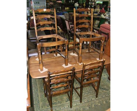 An Ercol Dining Table with rounded corners and rectangular top, on two flat shaped legs and sleigh style feet with 'H' stretc