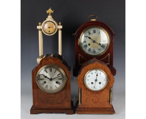 An early 20th century German mahogany mantel clock with eight day movement striking on a gong, the case with burr panel to fr