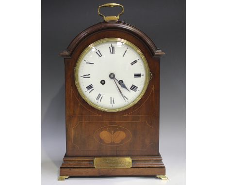 An Edwardian mahogany mantel clock with eight day movement striking on a gong, the white enamel circular dial with black Roma