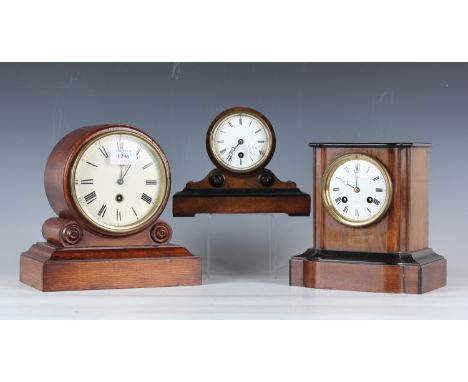 A late Victorian oak cased mantel timepiece, the painted circular dial with black Roman hour numerals, the drum case on scrol