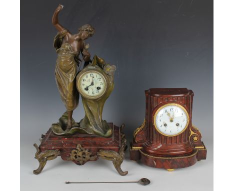 An early 20th century French spelter and rouge marble mantel clock with eight day movement striking on a bell, the foliate ca