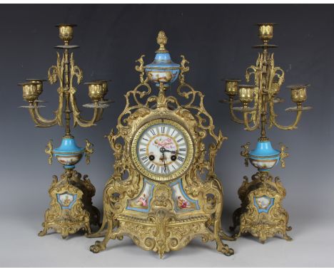 A late 19th century French gilt metal and Sèvres style porcelain clock garniture, the mantel clock with eight day movement st