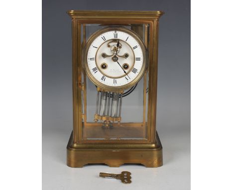 A late 19th century French brass four glass mantel clock with eight day movement striking on a gong, the backplate with 'Mart