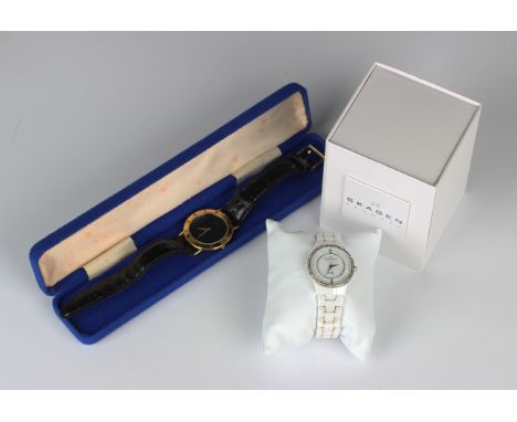 A Gucci gilt metal circular cased wristwatch with signed black dial, the bezel with black Roman numerals, case diameter 3.3cm