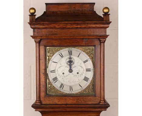 A George III oak longcase clock with eight day movement striking on a bell, the 11-inch square brass dial with silvered chapt