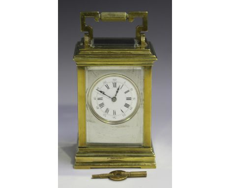 An early 20th century French brass cased carriage clock with eight day movement striking hours and half hours on a gong, the 