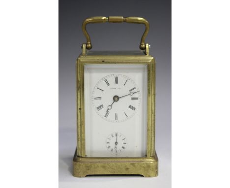 A late 19th century French brass one-piece cased carriage alarm clock with eight day movement striking on a bell, the enamel 