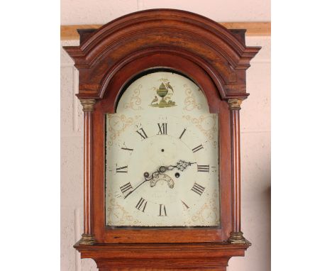 An early 19th century oak longcase clock with eight day movement striking on a bell, the painted breakarch dial mounted on a 