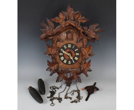 A late 19th/early 20th century Black Forest softwood cuckoo clock with two train weight driven movement, the dial with Gothic