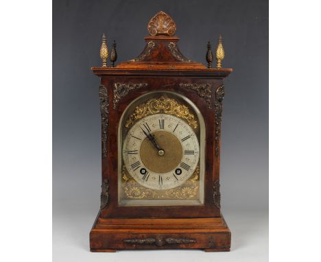 A late 19th century brass mounted burr walnut cased mantel clock with eight day movement striking hours and quarters on two g