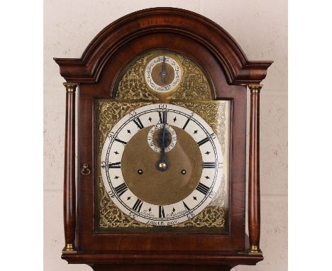 An early 20th century figured mahogany longcase clock with eight day movement striking on a bell, the 10-inch brass break arc