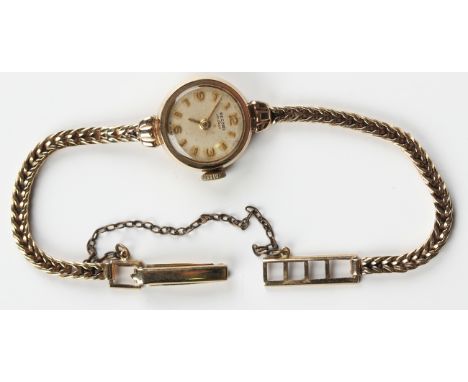 A Record de Luxe 9ct gold circular cased lady's bracelet wristwatch, the signed circular silvered dial with gilt Arabic numer
